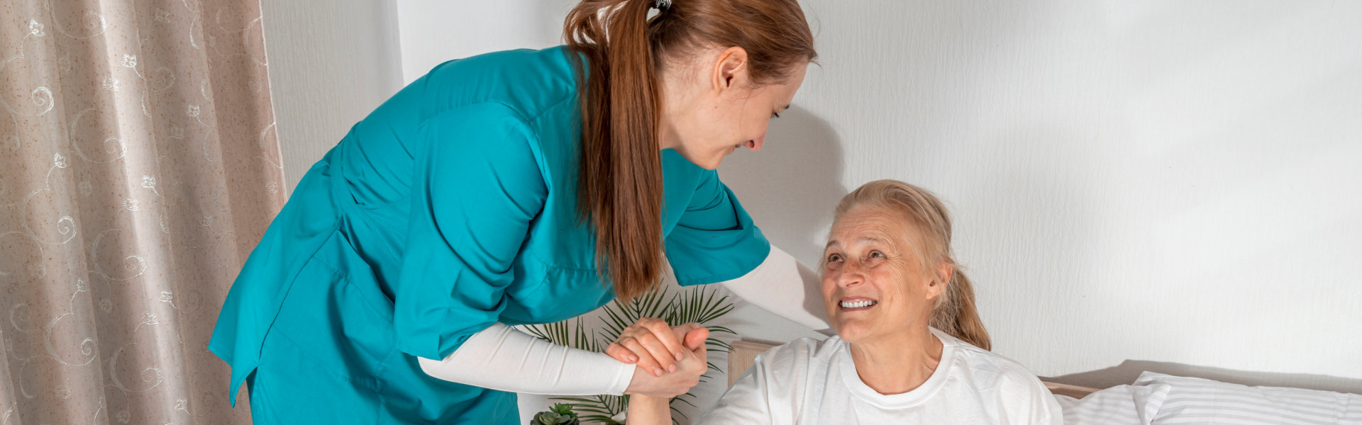 caregiver assissting the elderly to standup